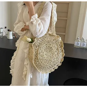 Detailed close-up of the hollow crochet pattern and woven texture on a cream straw bag