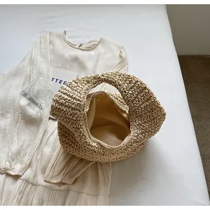 Detail of bohemian woven straw bag showing the smooth lining and secure zipper closure