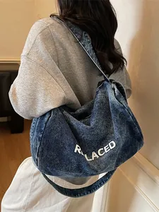 Retro washed blue denim crossbody bag for men and women with REPLACED logo print