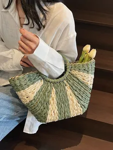 Handcrafted fan-shaped straw tote with green stripes, perfect for summer beach holidays
