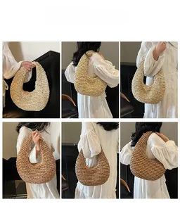 Detail showing handwoven cream and brown crescent beach bags held by a model