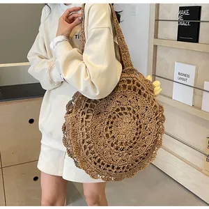 Close-up of Bohemian large capacity hollow lace woven straw shoulder bag for beach vacation