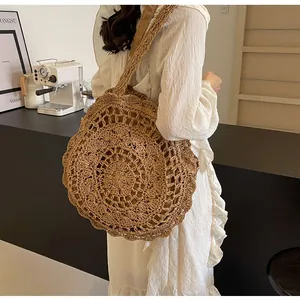 Close-up of bohemian hollow-out woven straw bag with circular radial patterns