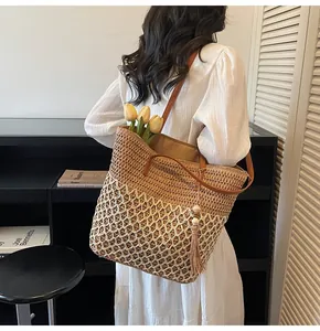 Détail du sac cabas tissé ajouré avec design color-block et pompon en perles de bois