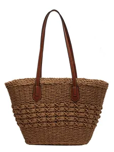 Handwoven straw tote bag with brown leather handles and diamond crochet pattern