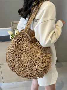 Large bohemian hollow-out crochet straw bag in caramel brown for summer beach vacations