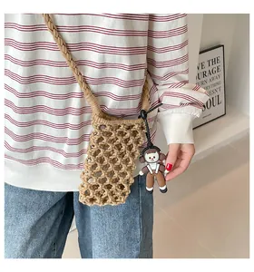 Detail of hand-woven cotton mesh mini crossbody bag with a cute silicone girl charm