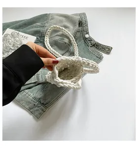 Top view of white hand-woven cotton mini bag showing internal texture and bucket shape