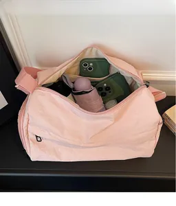 Top view of spacious interior in pink nylon tote bag with organized personal items