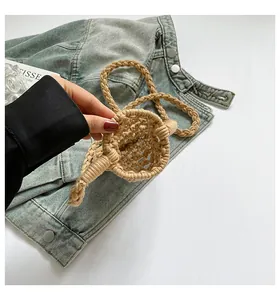 Macro shot of khaki cotton thread woven mini bag featuring hollow mesh and twisted handle