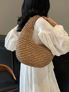 Bohemian hollow straw beach bag with half-moon woven texture for summer vacation use