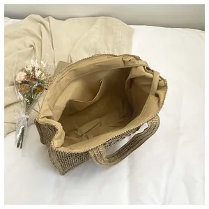 Close-up of woven straw beach bag with secure zipper closure and soft fabric lining