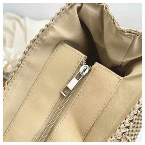 Detail shot of the woven beach bag with canvas lining and a secure metal zipper closure