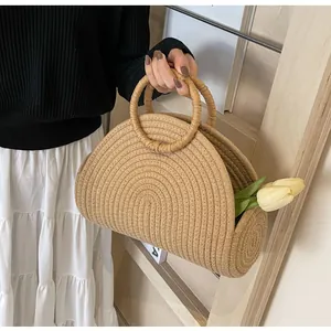 Macro view of semi-circular straw handbag with spiral woven texture and round handles
