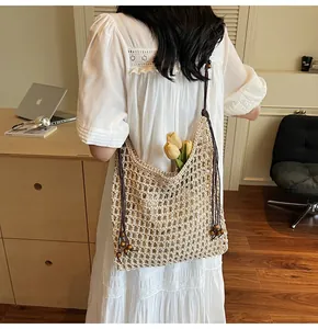 Detail of beige crochet tote bag with wooden beads and decorative tulip accents