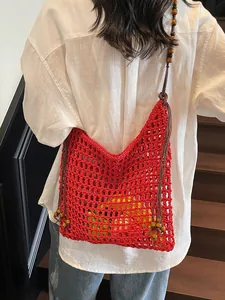 Handmade red hollow crochet tote bag with wooden bead straps for summer beach vacation