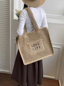 Large woven beach tote bag with LOVE LIFE embroidery and shoulder straps for vacation