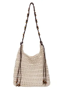 Hollow straw woven tote bag with beaded shoulder straps and long tassels for beach vacations