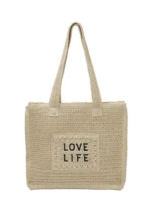Large beige woven straw tote bag with LOVE LIFE embroidery for beach vacation style