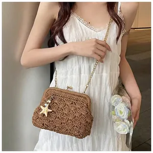 Detail of retro woven straw bag with gold metal clasp, chain strap and starfish charm