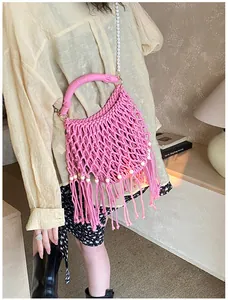 Pink bohemian crochet bag with tassels, wooden beads and elegant pearl shoulder strap
