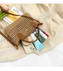 Detailed interior of woven straw bag showing spacious storage for makeup and phone