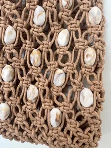 Detail of bohemian macramé woven bag featuring elegant marble textured beads