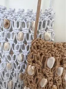 Detail of bohemian macrame woven bag with marble pattern beads and hollow mesh texture