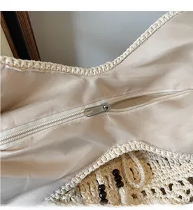 Close-up of smooth metal zipper and inner lining on crochet beach bag with beads