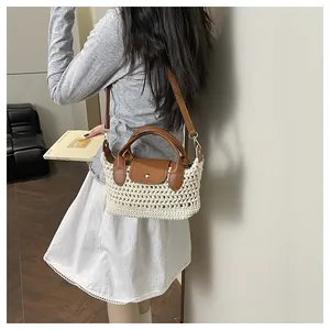 Detail showing beige crochet texture and brown leather strap of the summer crossbody bag
