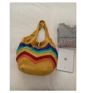 Makro-Detail des Wellenmusters auf der gelben Häkel-Strandtasche mit Regenbogen-Textur
