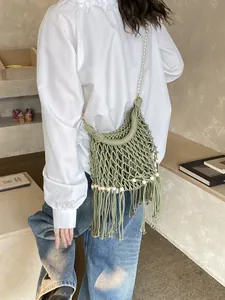 Bohemian grass green woven shoulder bag with long tassels and pearl strap detail