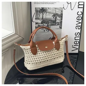 Close-up of beige woven texture with brown leather flap and gold metal buckle detail