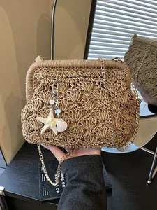Handmade woven straw crossbody bag with ocean theme charms and a gold chain strap