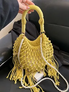 Bohemian yellow woven beach bag with fringe tassels and white pearl shoulder strap