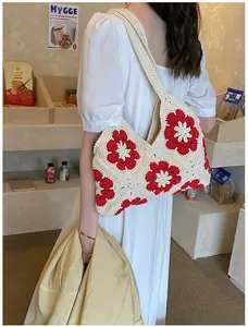Macro detail of hand-crocheted floral shoulder bag featuring 3D sunflower patterns