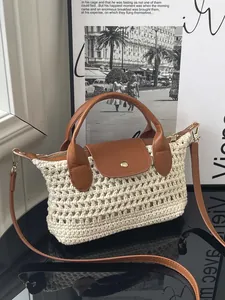Minimalist woven straw crossbody bag with brown leather trim and gold metal buckle