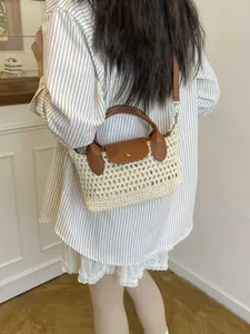 Chic woven beige bucket bag with brown leather flap and handle shown on model
