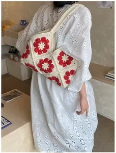 Bohemian crochet flower shoulder bag in beige cotton worn with a white summer dress