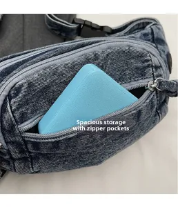 Macro shot showing the spacious storage compartment and smooth zipper of the denim chest bag