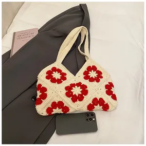 Detailed view of handmade crochet tote bag featuring vintage red floral patterns and texture