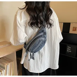 Detail showing the multi-zipper compartments of the retro washed denim crossbody bag