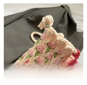 Close-up of the metal lobster clasp and handmade knitted floral pattern on the bag