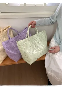 Close-up of laser-cut floral patterns on colorful waterproof jelly tote bags