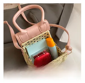 Detail view of mini straw bag interior with pink PU trim and polka dot lining