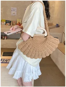 Close-up of brown woven fan-shaped handbag with smooth semi-circular wooden handles