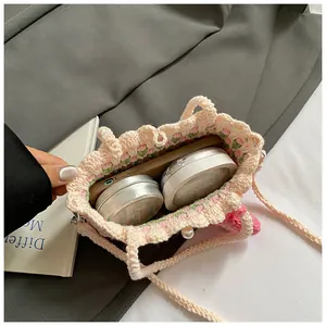 Detail of hand-knitted flower bag showing inner space for smartphone and cosmetics