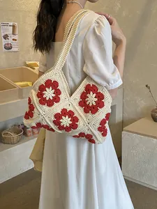 Handmade crochet shoulder bag featuring retro red floral motifs and a woven beige texture