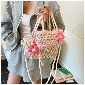 Macro view of handmade crochet tulip bucket bag set with detailed floral patterns