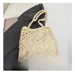 Close-up of beige crochet tote bag showing hollow daisy patterns and soft inner lining